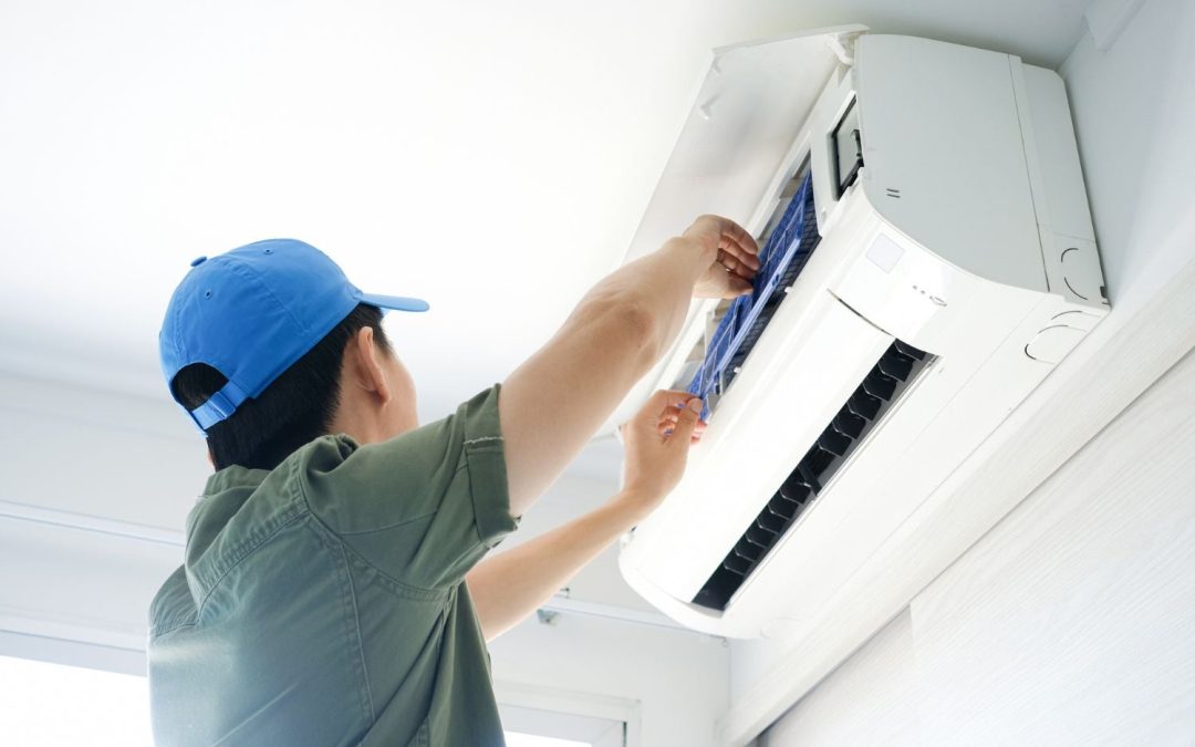 HVAC technician servicing a ductless mini split in San Carlos