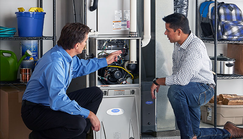 Technician evaluating a furnace for repair or replacement in San Carlos