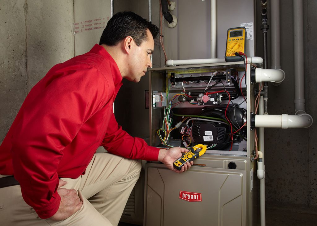 Heating technician diagnosing a furnace repair in San Carlos