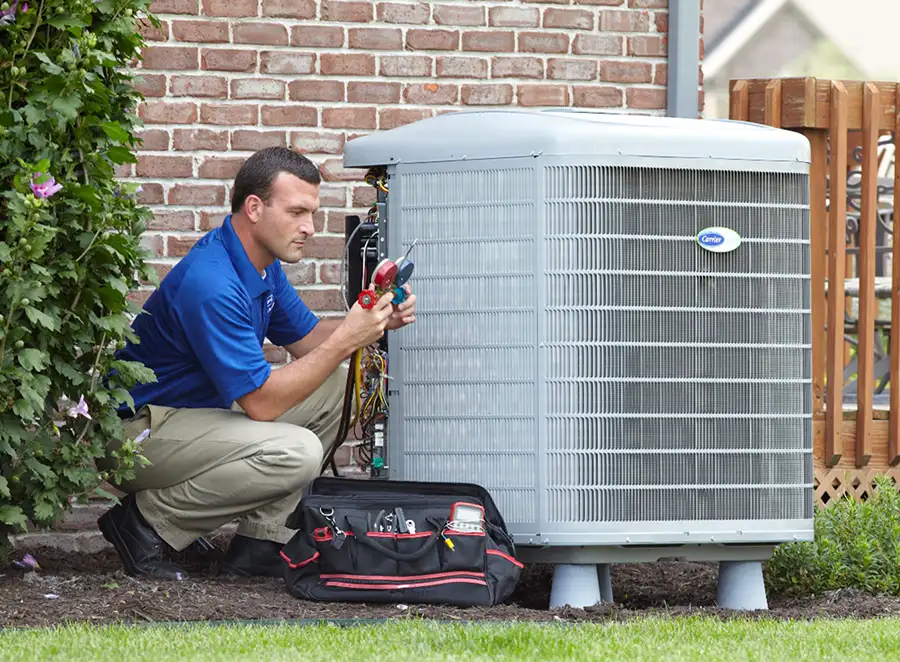 HVAC technician inspecting an outdoor AC unit in San Carlos