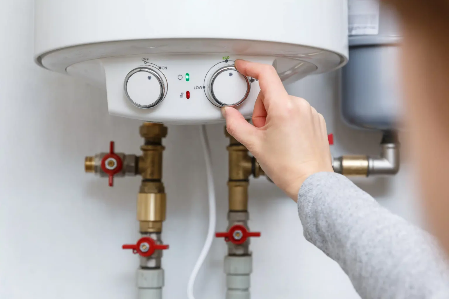 Technician adjusting a water heater in San Carlos